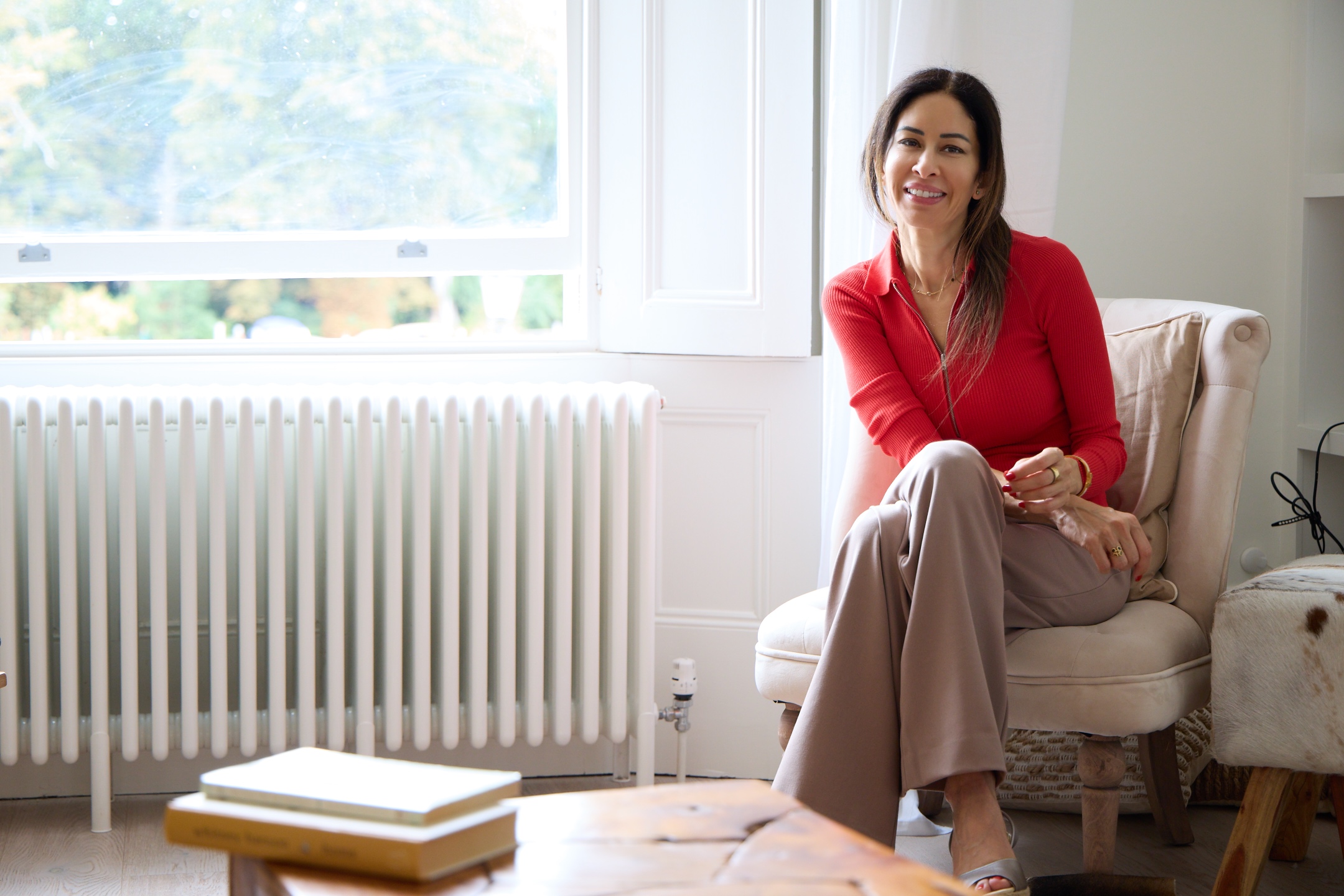 Lena Alami seated beside a bright window